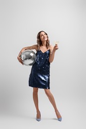 Photo of Beautiful woman with disco ball on white background