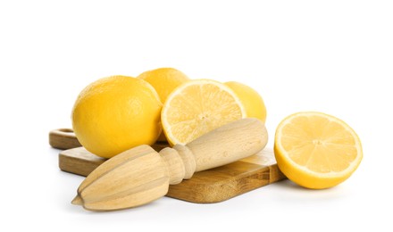 Photo of Wooden juicer and fresh lemons on white background