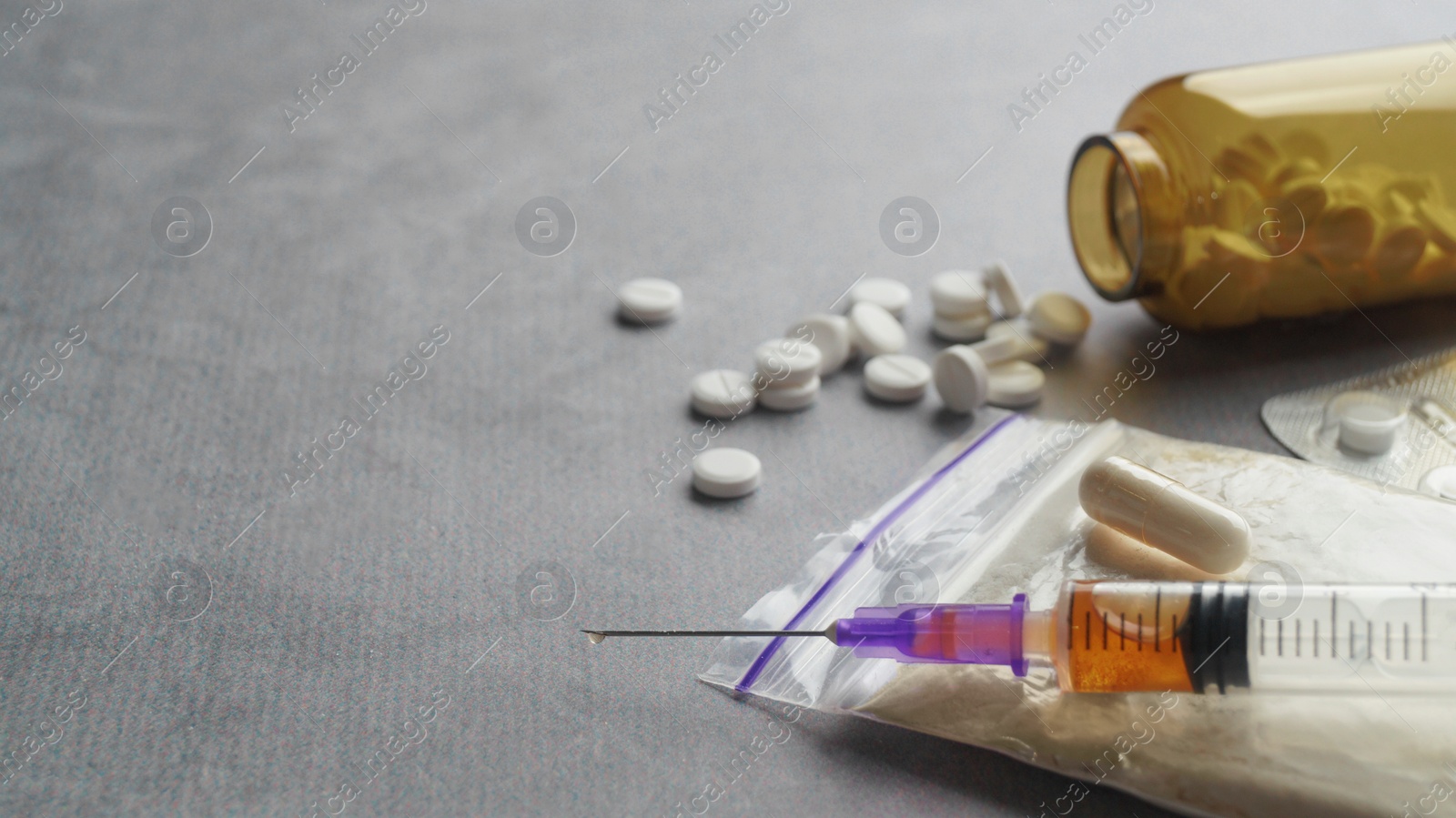 Photo of Different hard drugs on light grey table, closeup. Space for text