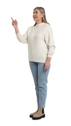 Photo of Senior woman pointing at something on white background