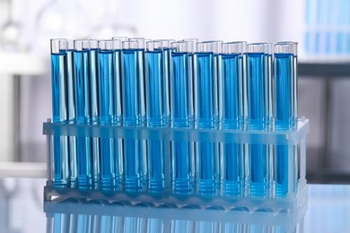 Photo of Test tubes with reagents on table in laboratory