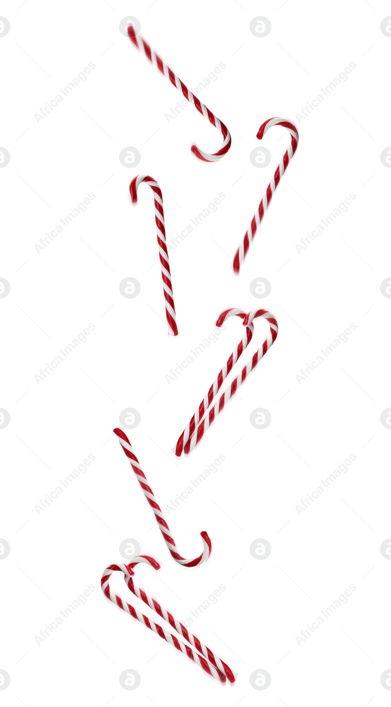 Image of Tasty Christmas candy canes falling on white background