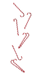 Image of Tasty Christmas candy canes falling on white background