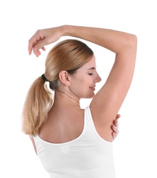 Young woman showing armpit on white background. Using deodorant