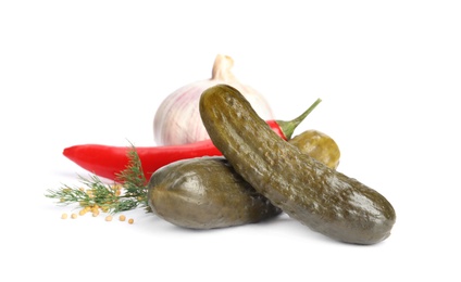 Photo of Pickled cucumbers with products on white background
