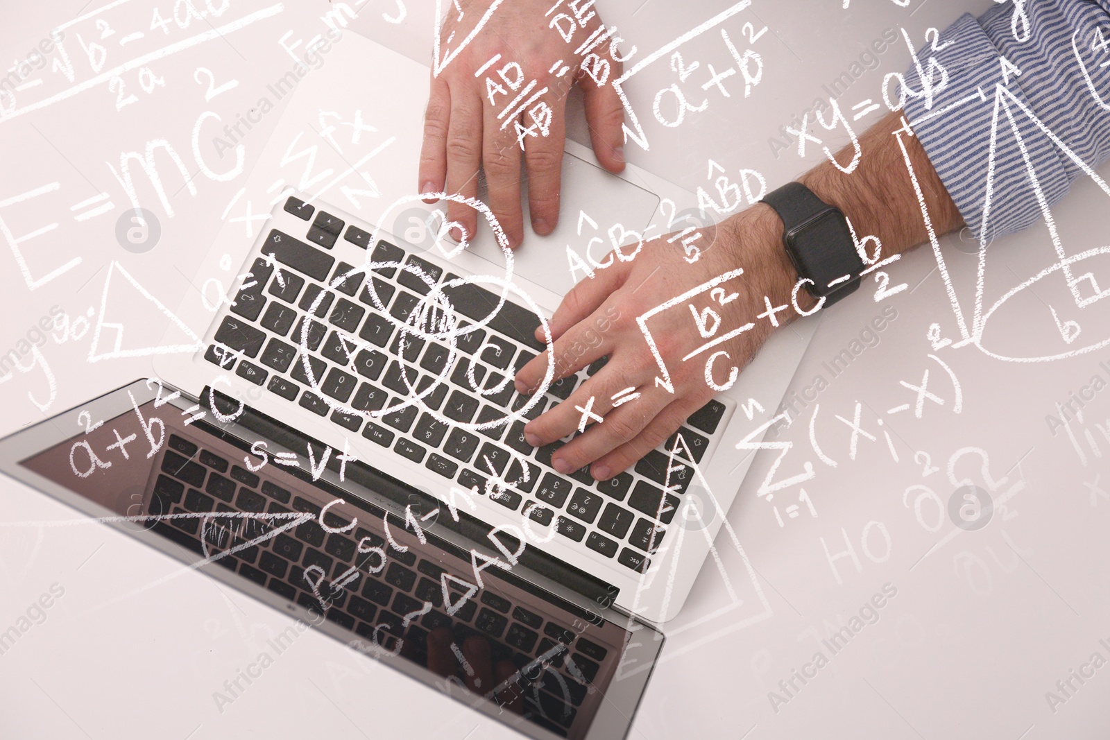 Image of Science and education concept. Illustration of basic physics and mathematics formulas and man working on laptop at table, top view