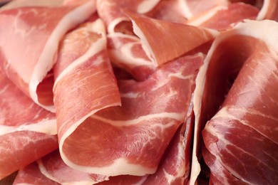 Slices of tasty cured ham as background, closeup