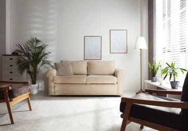 Photo of Living room interior with comfortable sofa near window