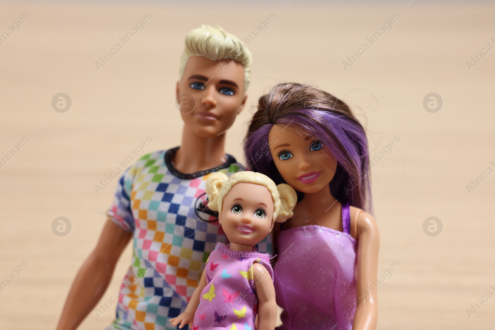 Photo of Leiden, Netherlands - September 20, 2023: Beautiful Barbie, Ken and Chelsea dolls on beige background