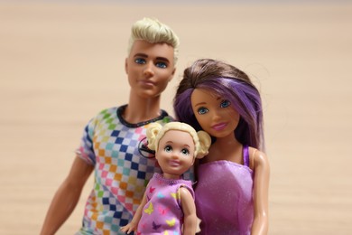 Leiden, Netherlands - September 20, 2023: Beautiful Barbie, Ken and Chelsea dolls on beige background