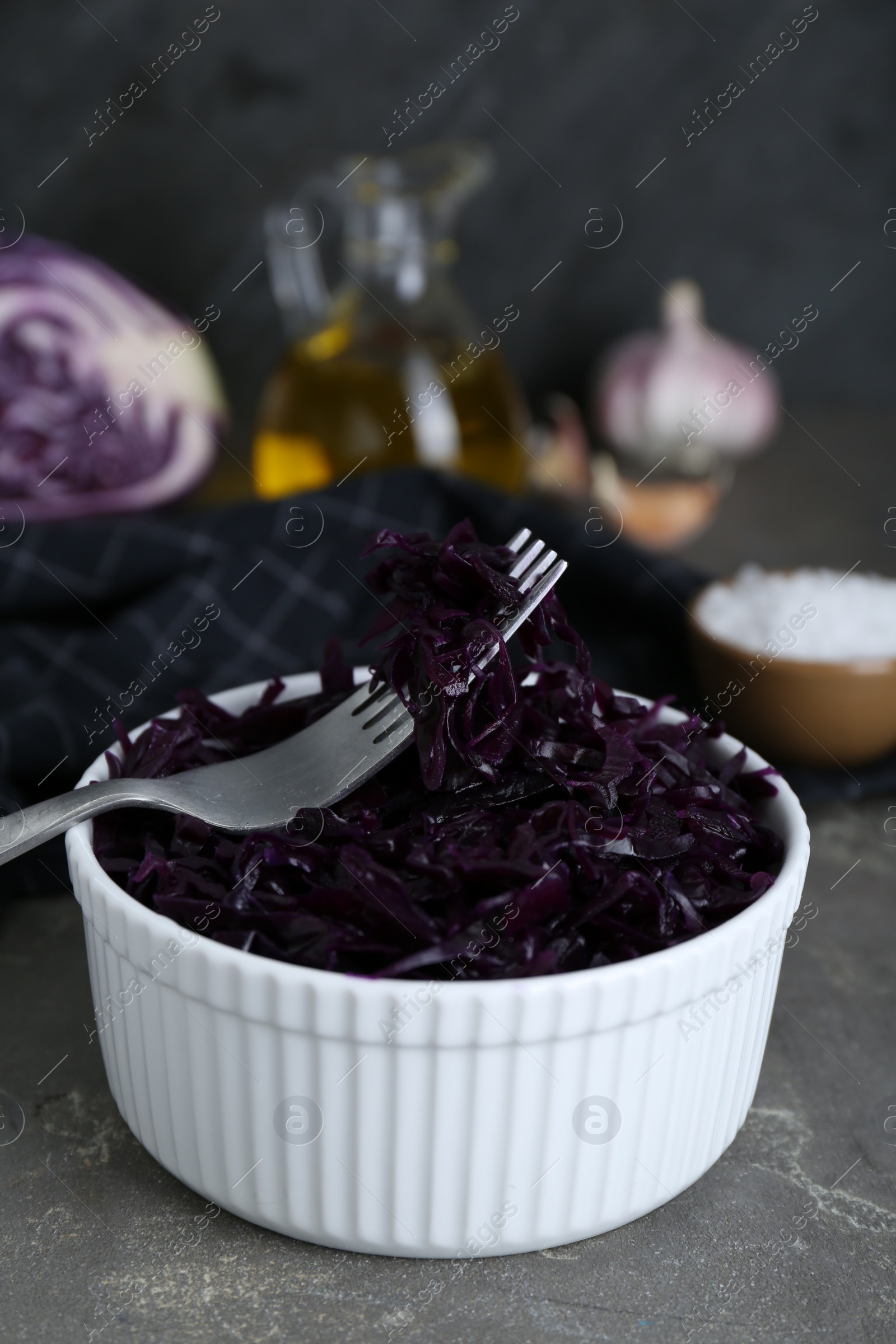 Photo of Tasty red cabbage sauerkraut on light grey table