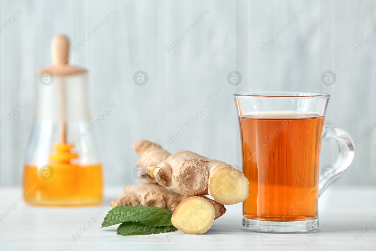 Photo of Cup of tea, mint and ginger on table. Space for text