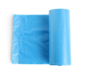 Photo of Roll of turquoise garbage bags on white background, top view. Cleaning supplies