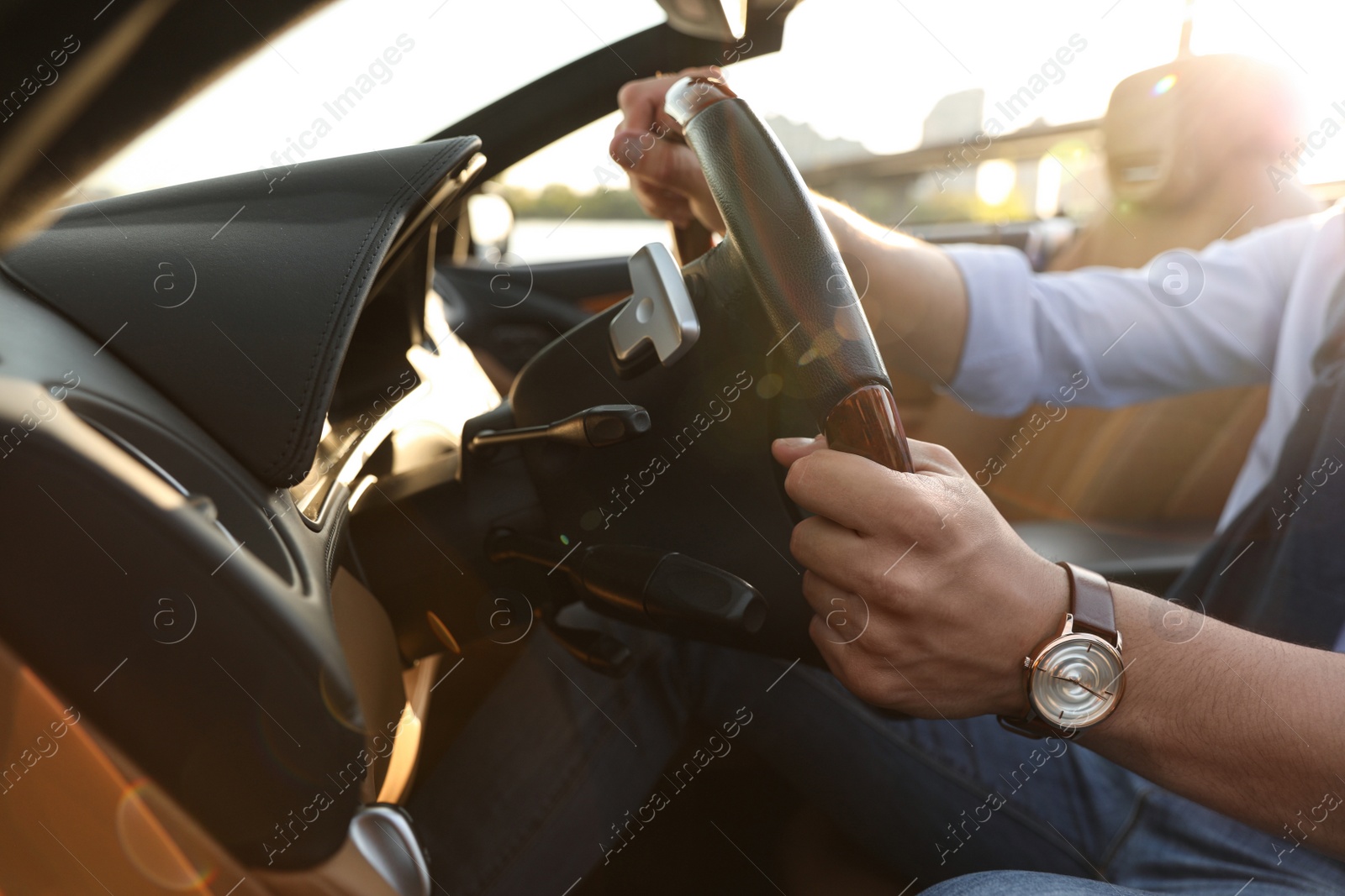 Photo of Stylish man driving luxury convertible car, closeup