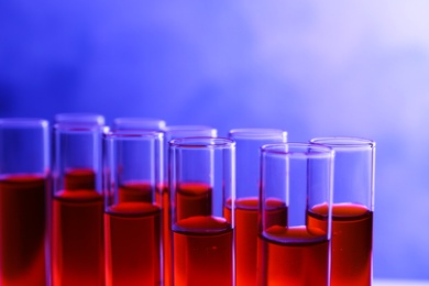 Closeup view of many test tubes with red liquid, color tone effect