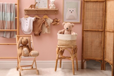 Cute room interior with baby clothes and toys