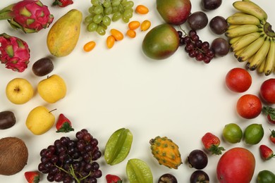 Photo of Frame of fresh exotic fruits on white background, flat lay. Space for text