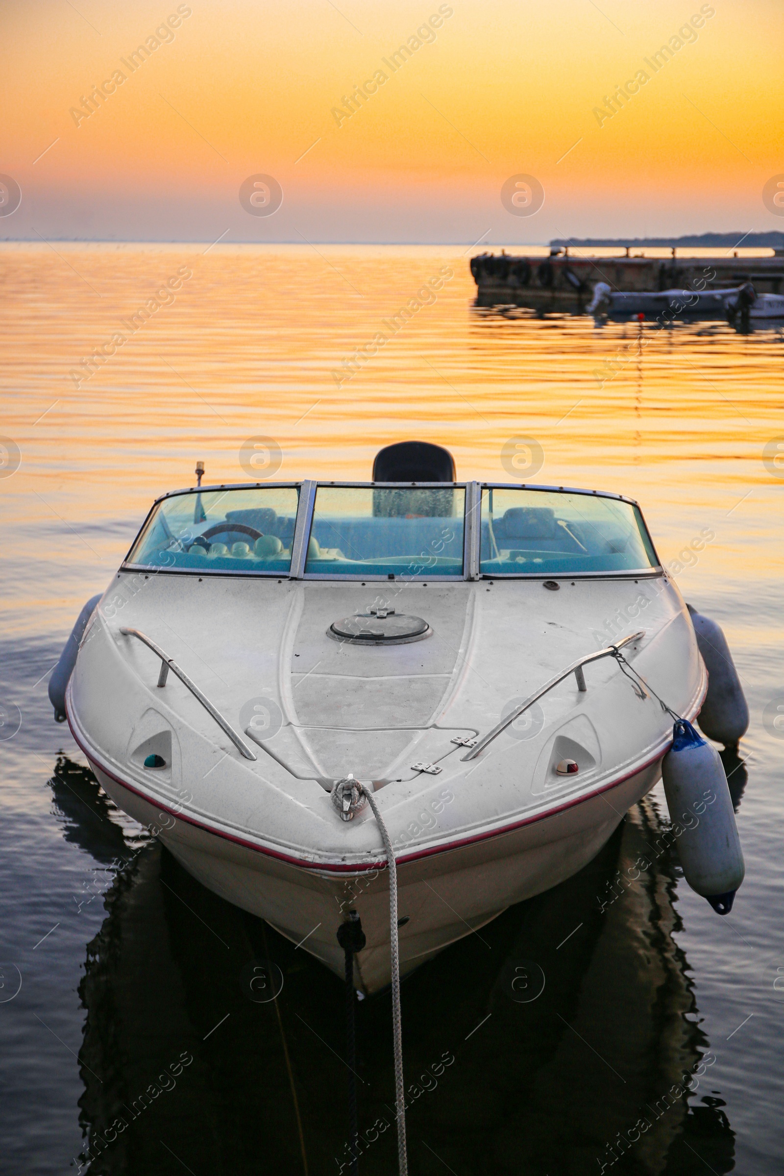 Photo of Beautiful view of river with moored boat at sunset