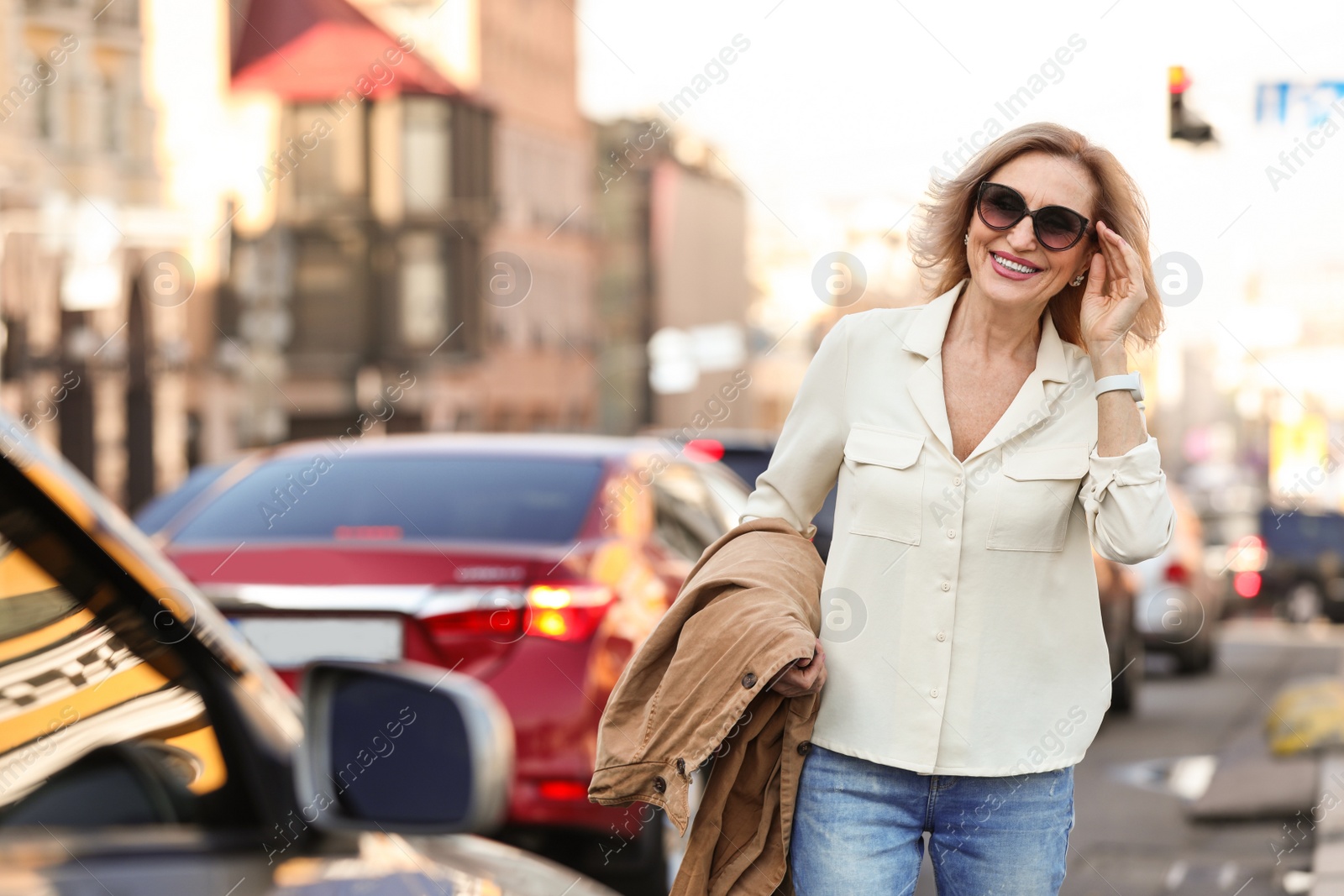 Photo of Beautiful mature woman with sunglasses on city street