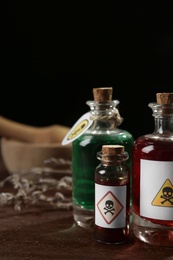 Photo of Bottles with poisons on wooden table. Space for text