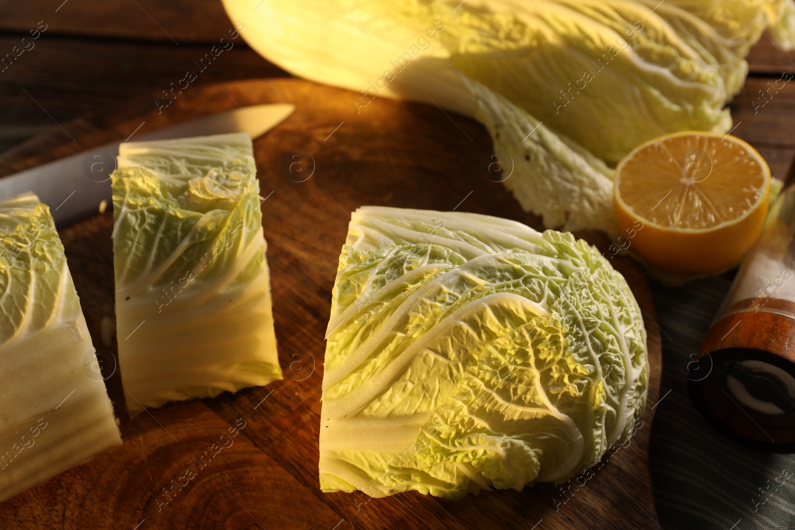 Photo of Fresh Chinese cabbage and lemon on table, closeup