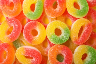 Photo of Many tasty jelly candies as background, top view