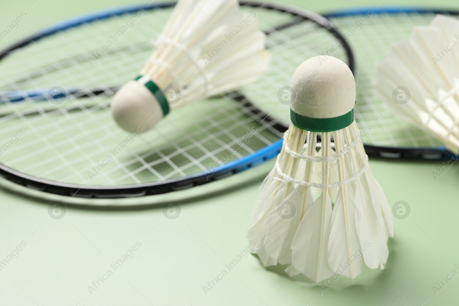 Photo of Feather badminton shuttlecock on green background, closeup