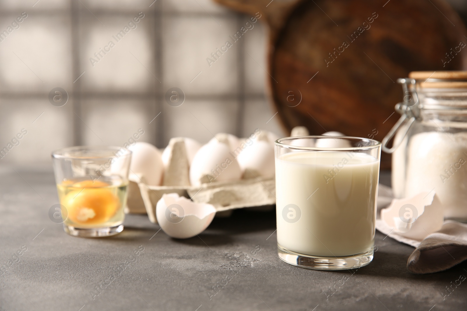 Photo of Different ingredients for dough on grey table, closeup