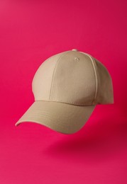 Photo of Baseball cap on pink background. Mock up for design