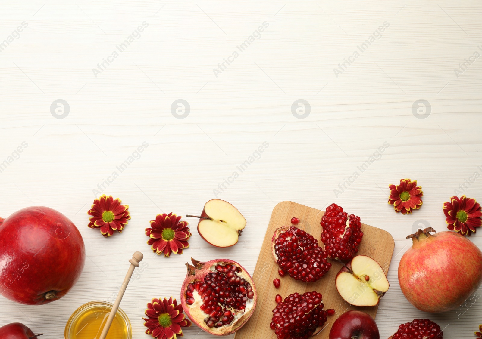 Photo of Flat lay composition with Rosh Hashanah holiday attributes on white wooden table. Space for text