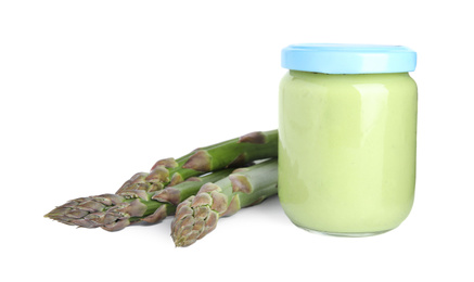 Jar with healthy baby food and fresh asparagus on white background