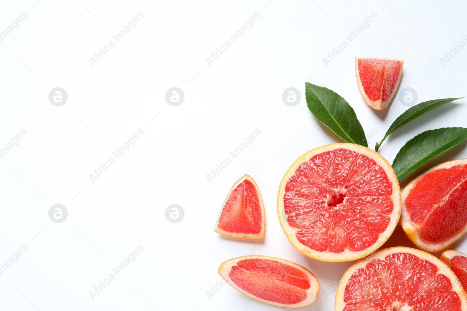 Photo of Grapefruits and leaves on white background, top view. Citrus fruits