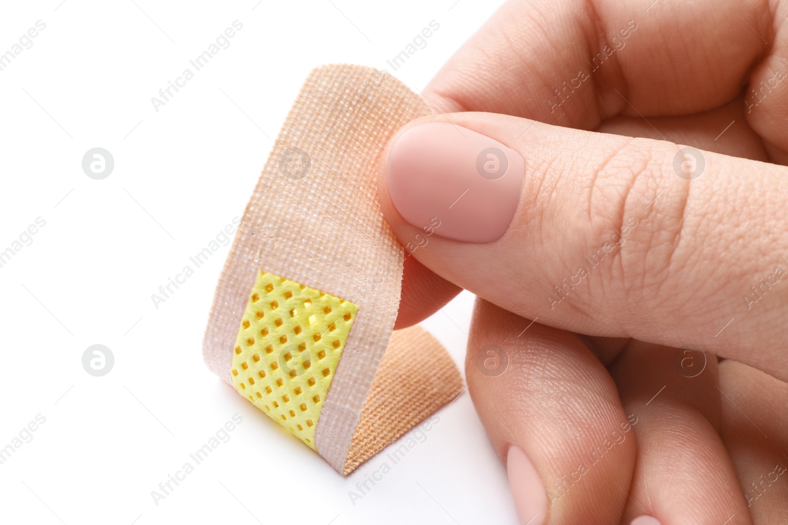 Woman putting sticking plaster on white background, closeup. First aid item Photo of Woman putting sticking plaster on white background, closeup. First aid item