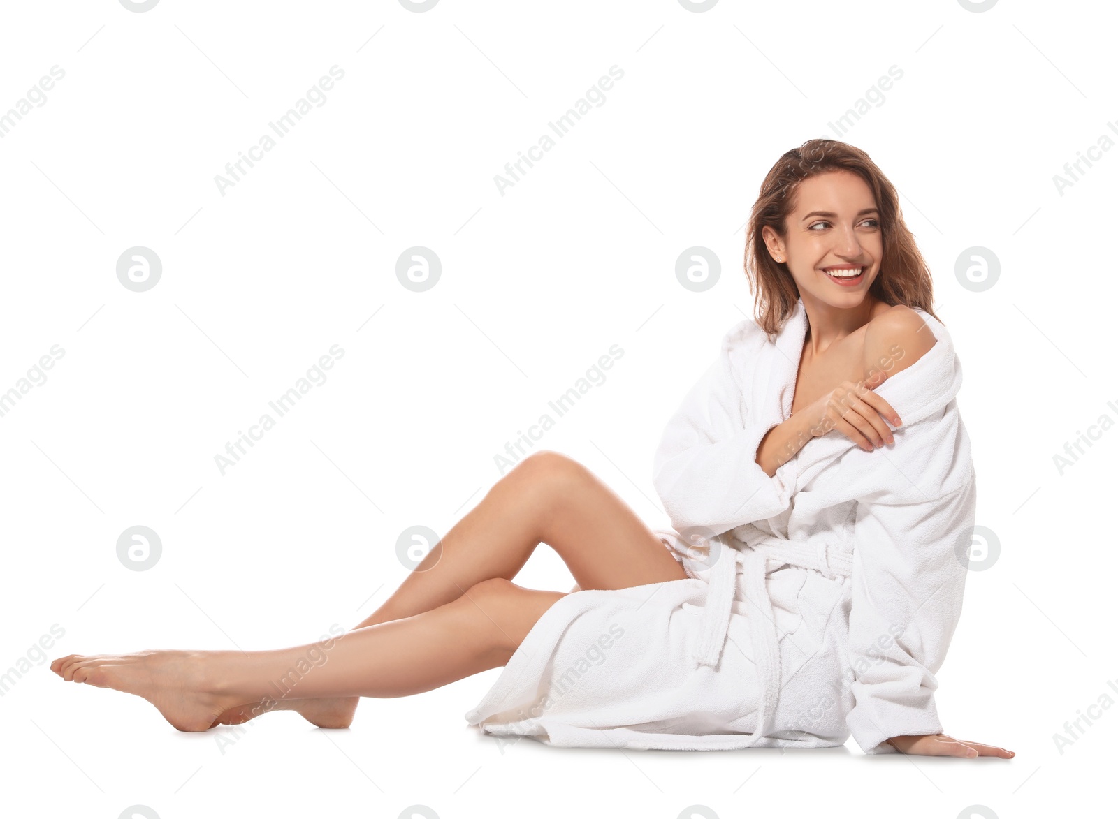 Photo of Beautiful young woman wearing bathrobe on white background
