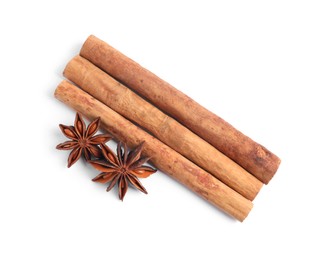 Aromatic cinnamon sticks and anise stars isolated on white, top view