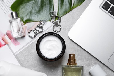 Photo of Flat lay composition with hand care cosmetic products on light grey table