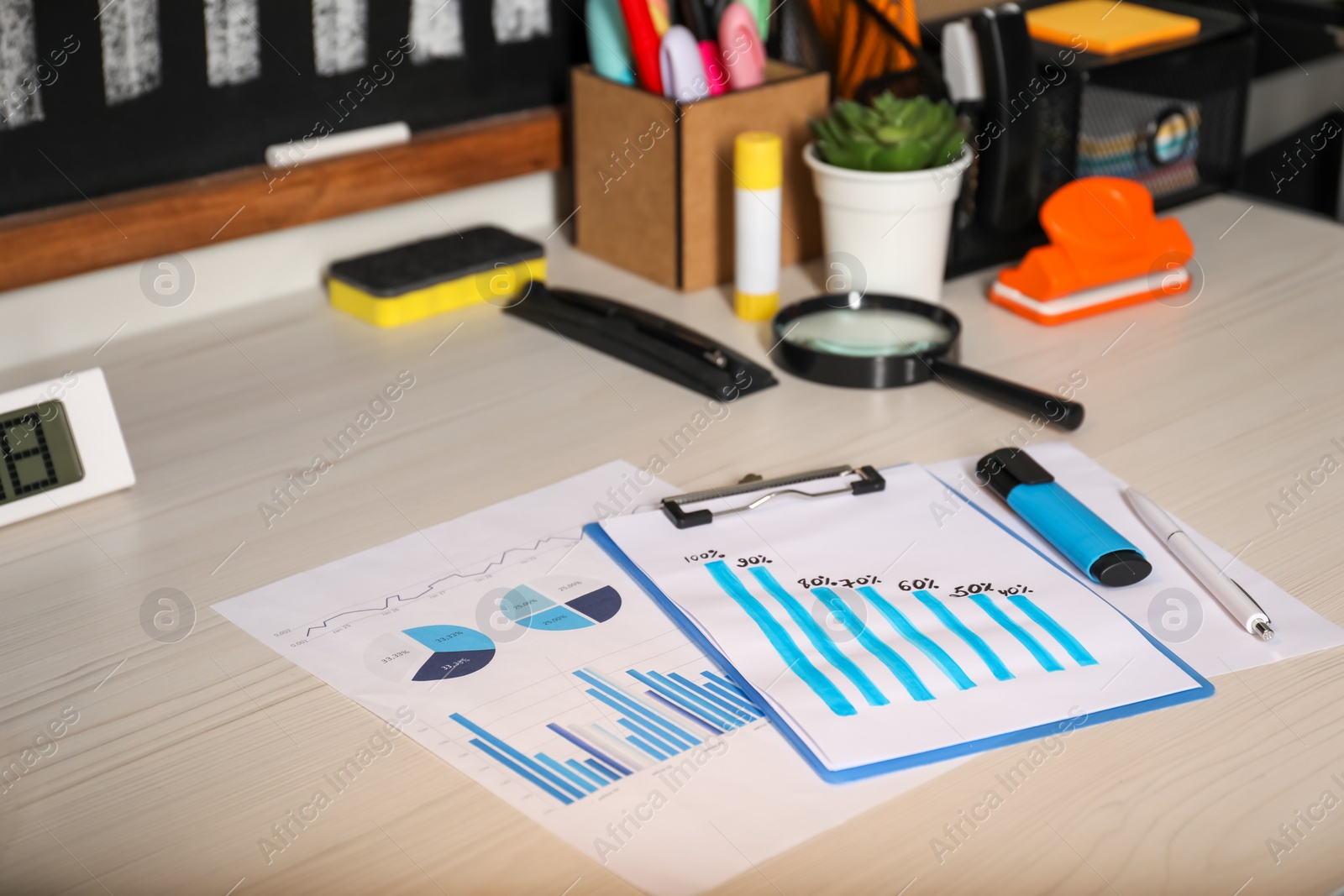 Photo of Business process planning and optimization. Workplace with different graphs and other stationery on wooden table