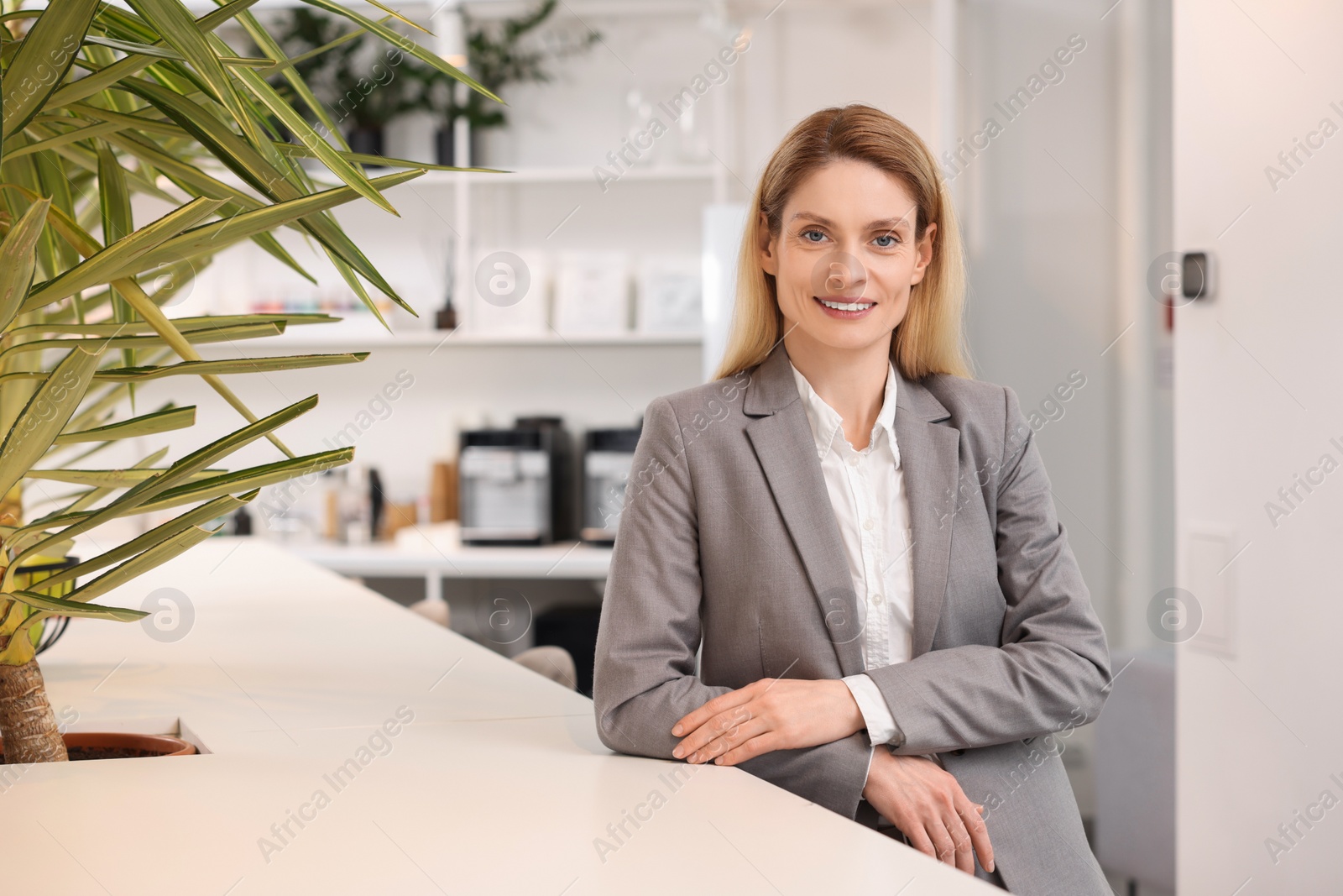 Photo of Female real estate agent indoors. Space for text