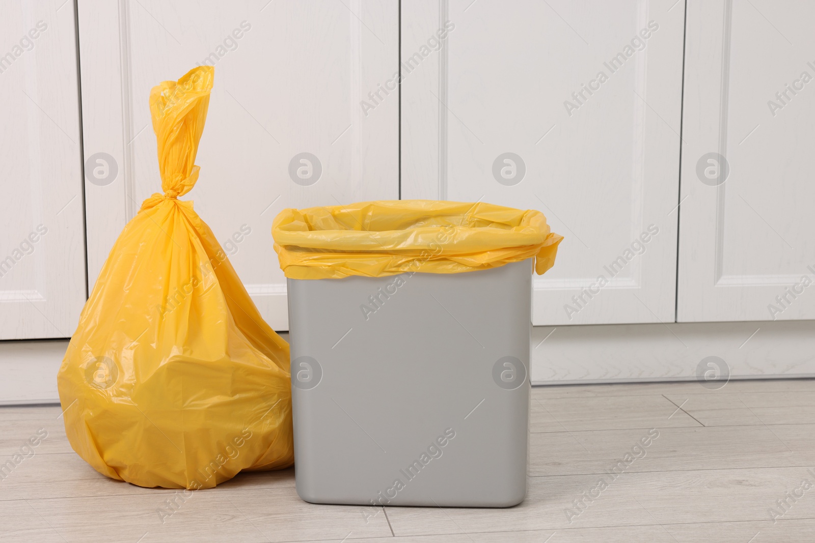 Photo of Plastic garbage bag and trash can indoors