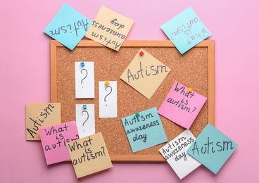 Sticky notes with autism related phrases on cork board