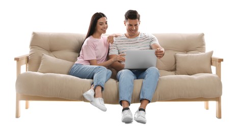 Happy couple with laptop on comfortable sofa against white background