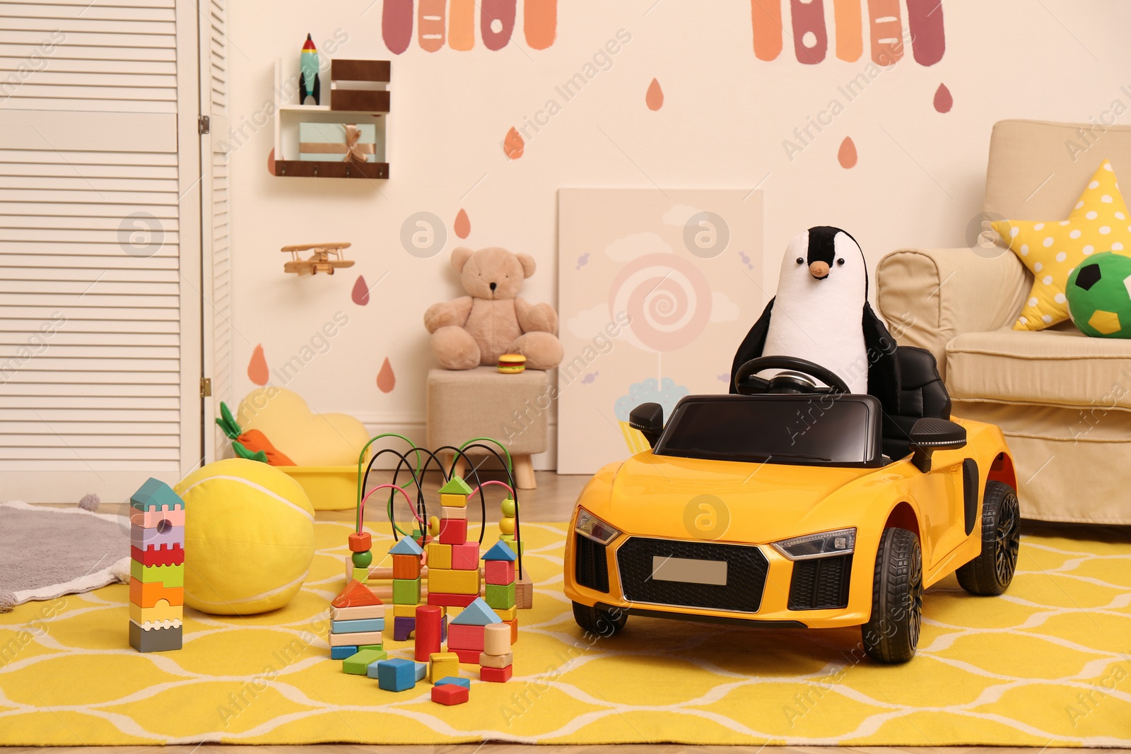 Photo of Child's electric car and other toys in playroom