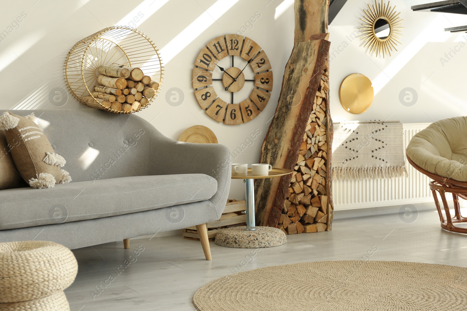 Photo of Stylish room interior with firewood as decorative element