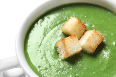 Fresh vegetable detox soup with croutons in dish, closeup