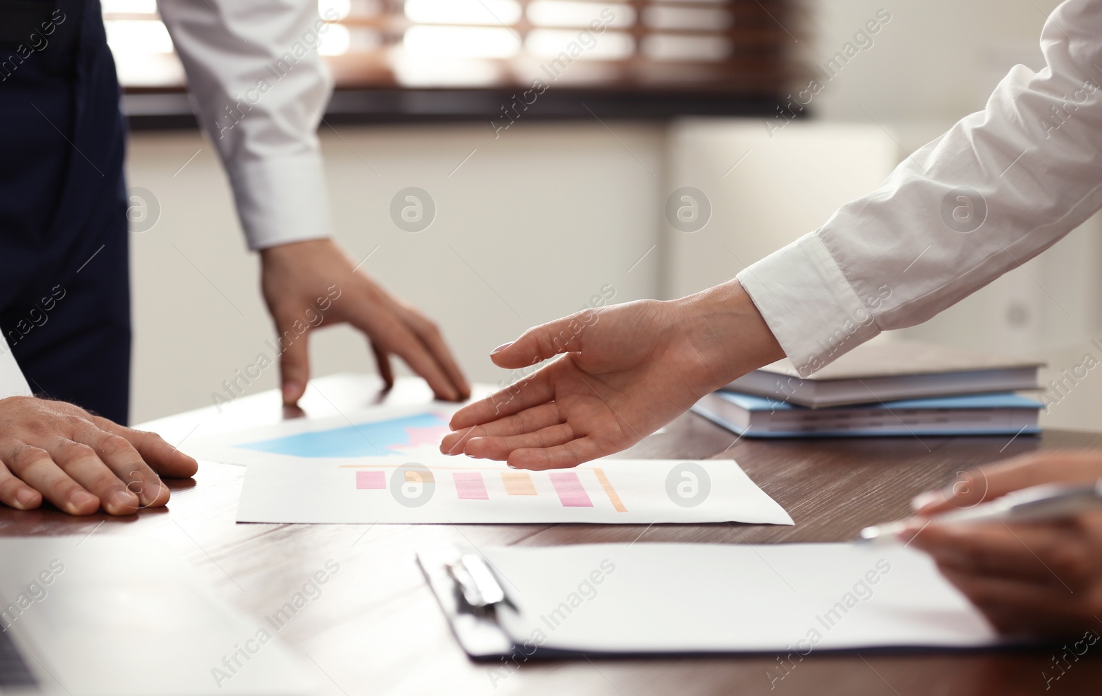 Photo of Business trainer and client working at table in office, closeup