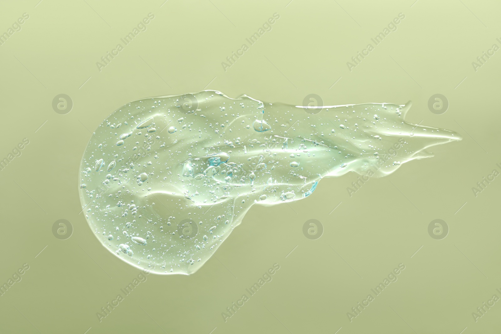 Photo of Sample of cleansing gel on pale green background, top view. Cosmetic product