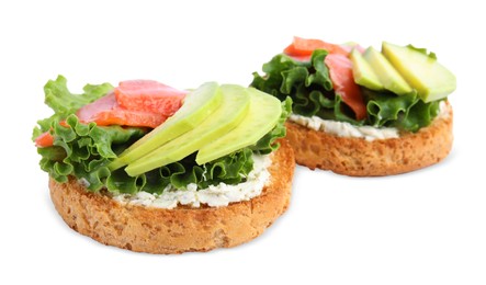 Photo of Tasty rusks with salmon, cream cheese and avocado isolated on white