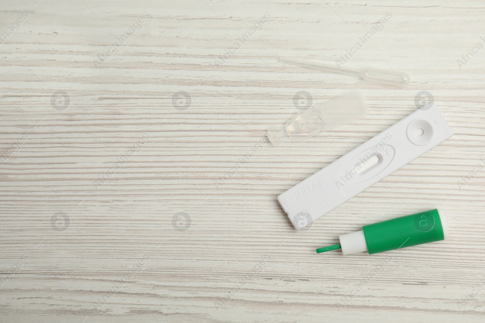 Photo of Disposable express hepatitis test kit on white wooden table, flat lay. Space for text