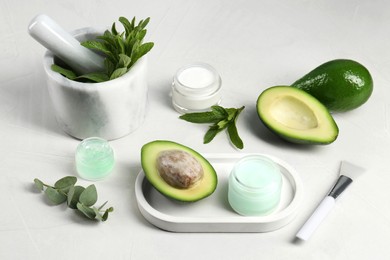 Homemade cosmetic products and fresh ingredients on white table
