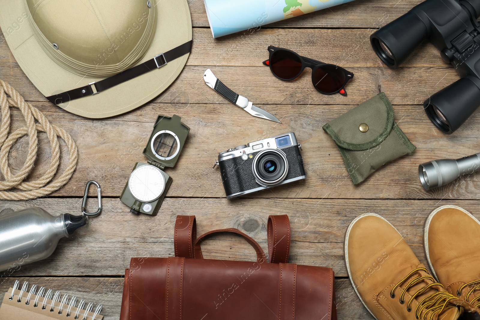 Photo of Flat lay composition with different safari accessories on wooden background